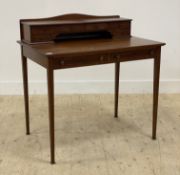 An Edwardian mahogany bonheur de Jour writing desk, the cabinet back fitted with six drawers,