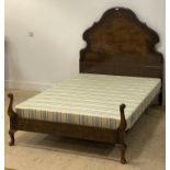 A 1930's cross banded burr walnut double bed frame, the headboard of undulating outline, opposed