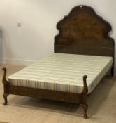 A 1930's cross banded burr walnut double bed frame, the headboard of undulating outline, opposed