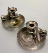A pair of late Victorian Epns chamber candlestick holders with leaf scroll handles complete with