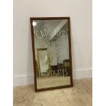 An early 20th century Cadburys etched glass advertising mirror in an oak frame with paper label