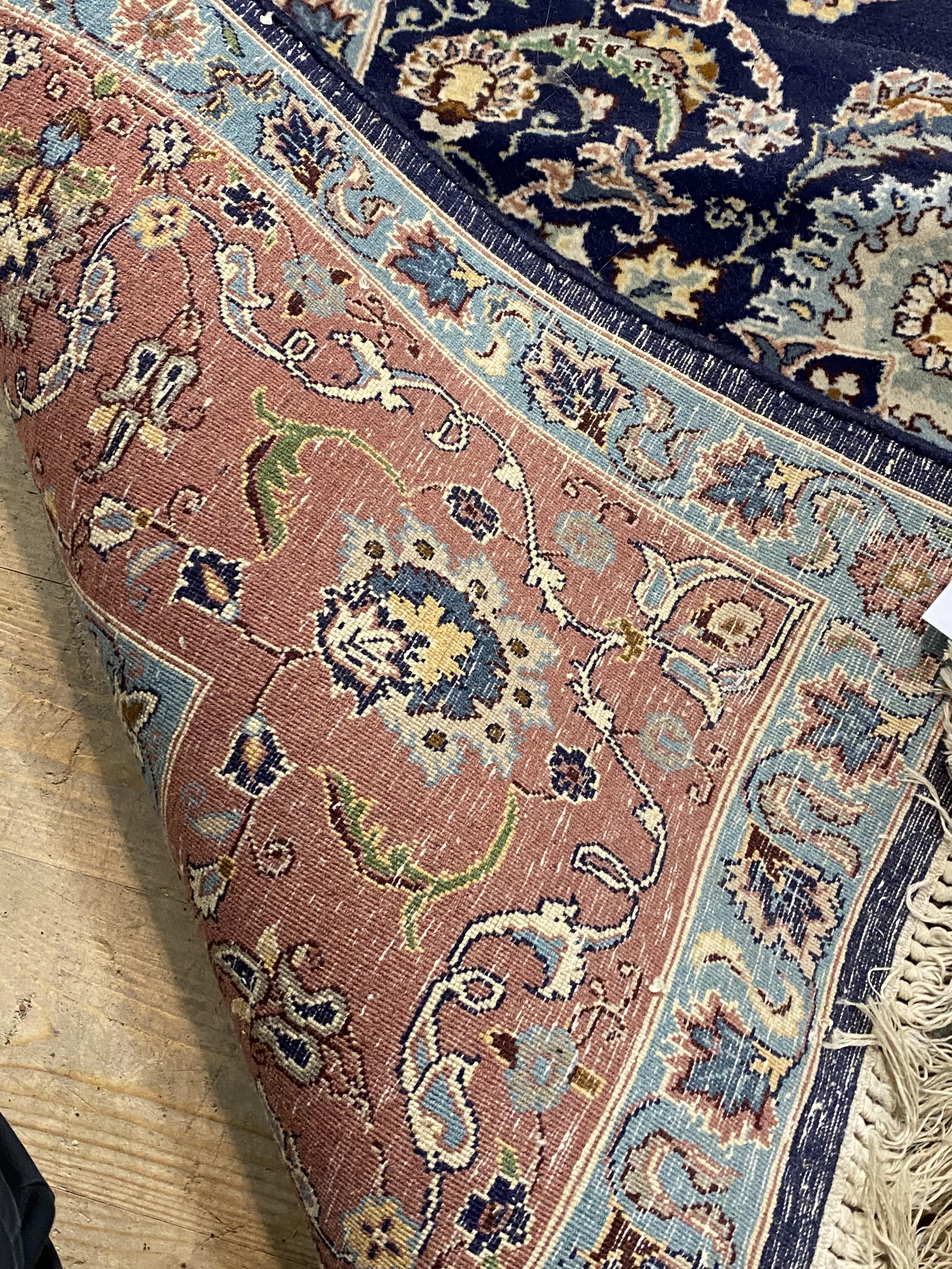 A Persian style rug, the dark blue field with centre medallion and lotus head motifs and bordered - Image 2 of 2