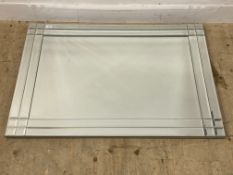 A contemporary bevel glazed wall hanging mirror. 81cm x 112cm.