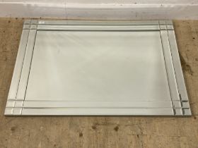 A contemporary bevel glazed wall hanging mirror. 81cm x 112cm.