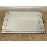 A contemporary bevel glazed wall hanging mirror. 81cm x 112cm.