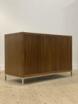 A contemporary oak side cabinet, fitted with three fluted doors opening to a fitted interior, raised