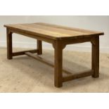 A large traditional reclaimed pine refectory type dining table, the rectangular top raised on square