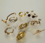 A collection of earrings to include a pair of 9ct gold garnet stud earrings, a pair of 9ct gold knot