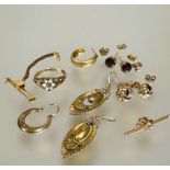 A collection of earrings to include a pair of 9ct gold garnet stud earrings, a pair of 9ct gold knot