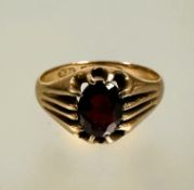 A 9ct gold garnet set dress ring in twelve claw fluted setting, stone included S 3.83g