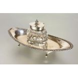 A Edwardian Birmingham silver navette shaped desk inkstand with original faceted silver topped
