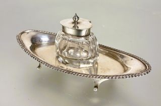 A Edwardian Birmingham silver navette shaped desk inkstand with original faceted silver topped