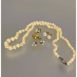 A graduated cultured pearl necklace with silver paste set clasp fastening one stone missing L x 26cm