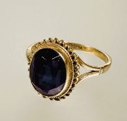A 9ct gold oval faceted amethyst collette set dress ring with rope pattern border approximately