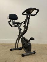 A 'Magic life' exercise bicycle. H1116cm .