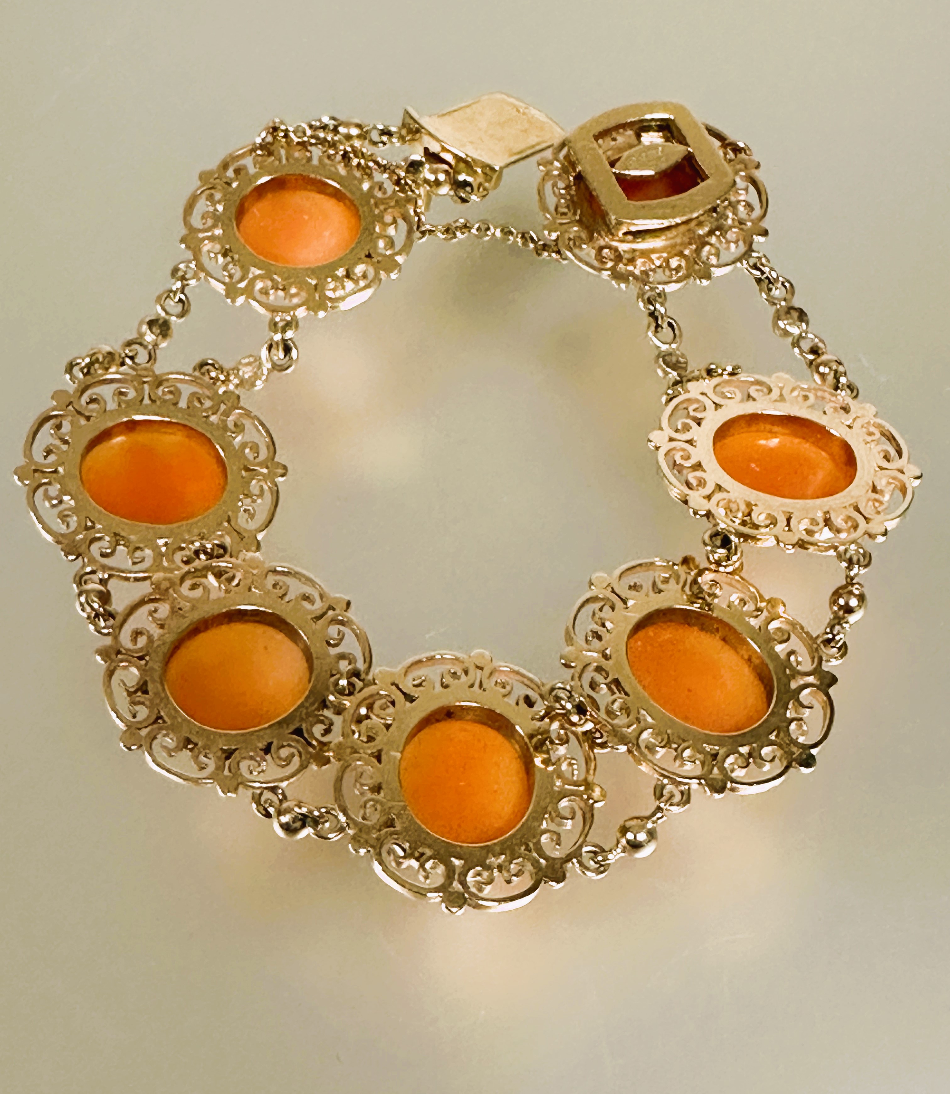 A 9ct gold bracelet set seven shell carved cameos in scrolling open work setting between chain - Image 2 of 4