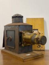 A Victorian brass and tin magic lantern by J. Lizars of Aberdeen, on an oak base L60cm.