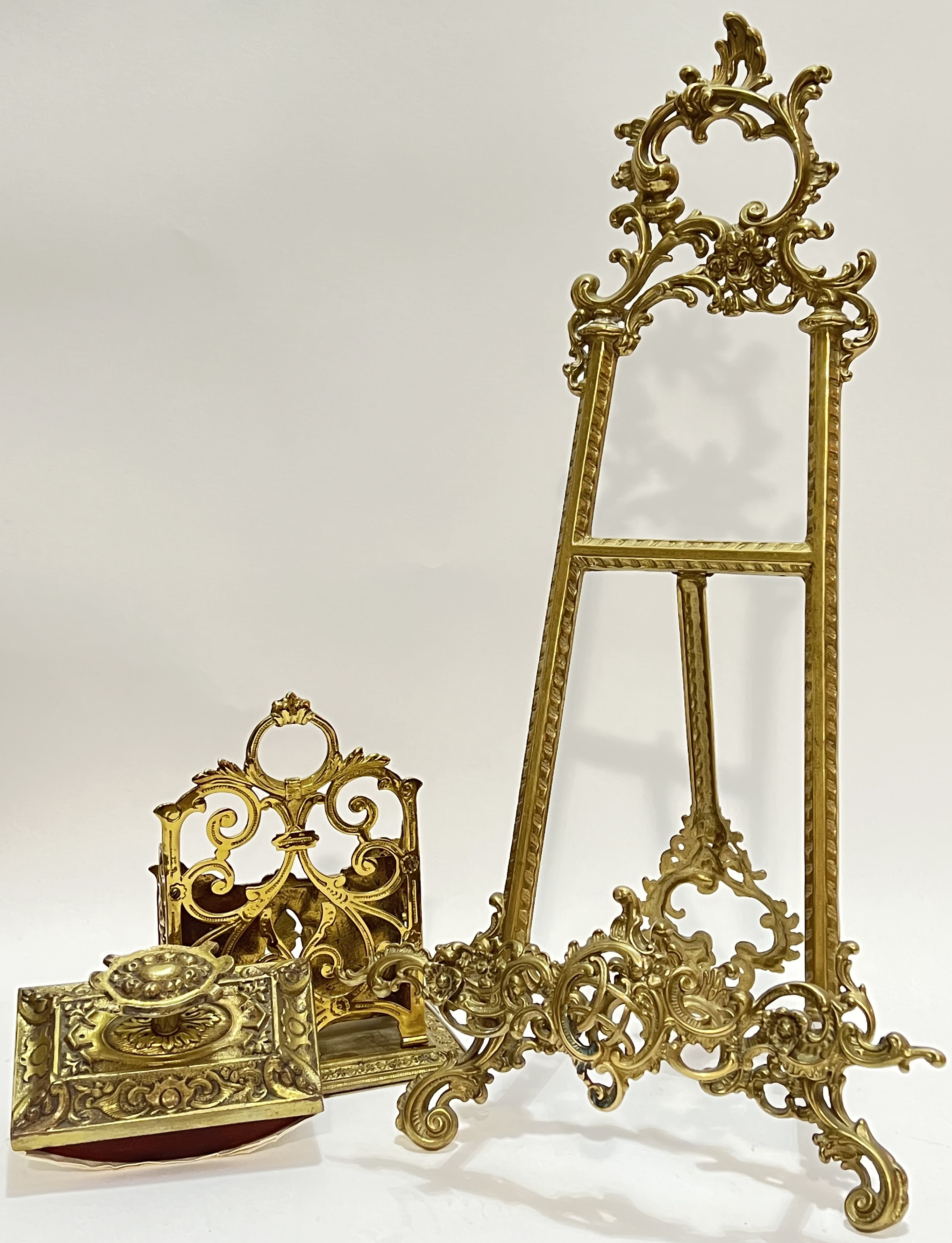 A Rococo style brass easel stand (h- 54cm, w- 28cm), together with a pierced brass letter rack and a
