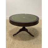 A Regency style mahogany drum table, the circular top inset with tooled green leather surface, above