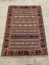 A hand knotted Soumak rug, brightly coloured and of lineal design. 126cm x 190cm.