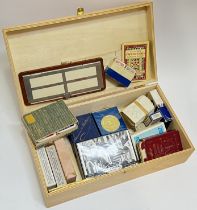 A box of various decks of playing cards and games aides for Bridge etc...