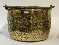 A 19th century hammered brass log bucket, with wrought iron swing handle, and floral motifs. D43cm.