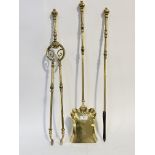 A late Victorian three piece cast brass fireside companion set, comprising a poker, pair of tongs,