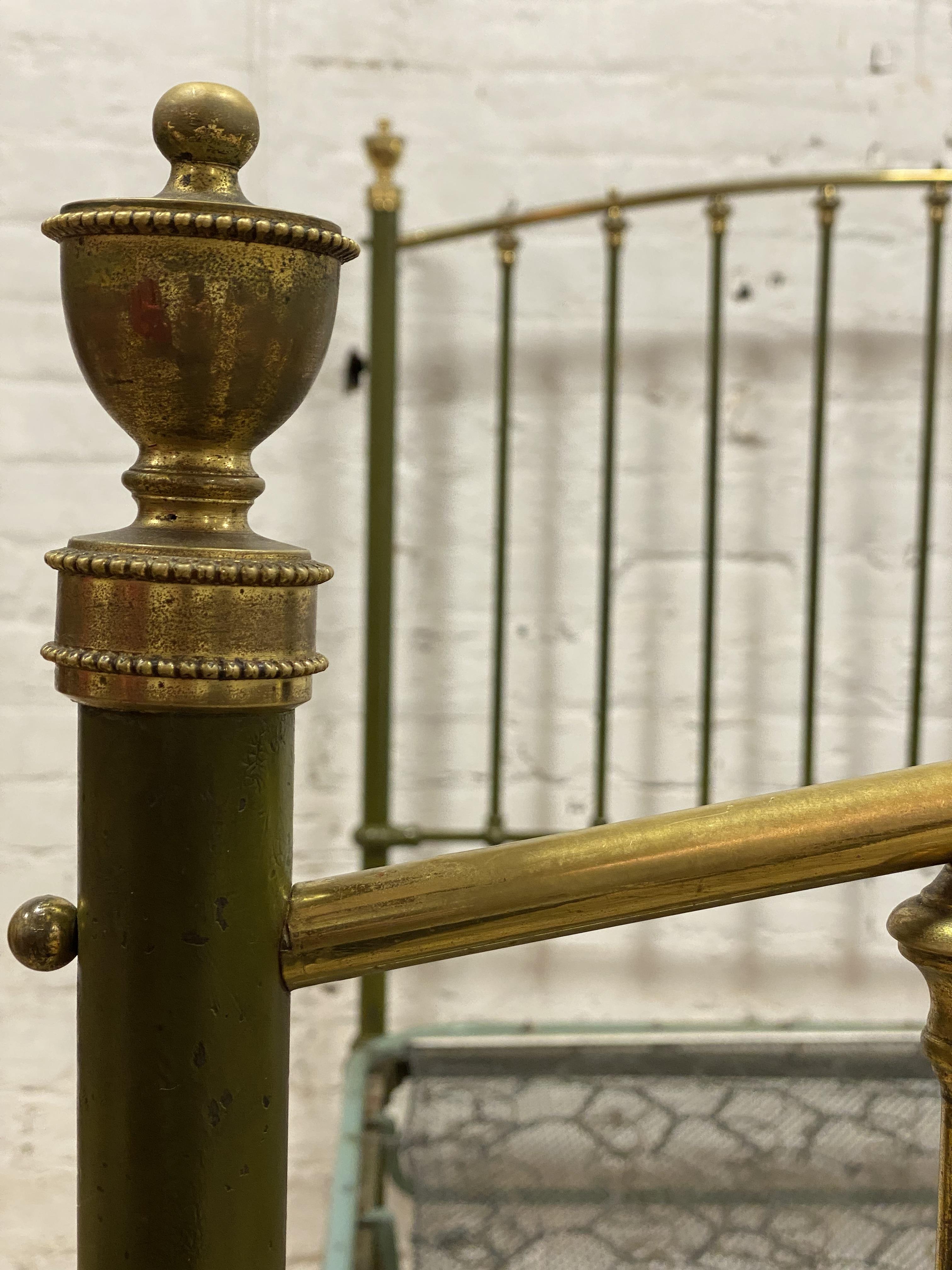 An Edwardian brass and green lacquered double bed frame, with urn finials, sprung base and moving on - Image 2 of 2