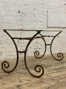 A 19th century French wrought iron patisserie table base of scrolling form, H73cm, D142cm, L72cm.