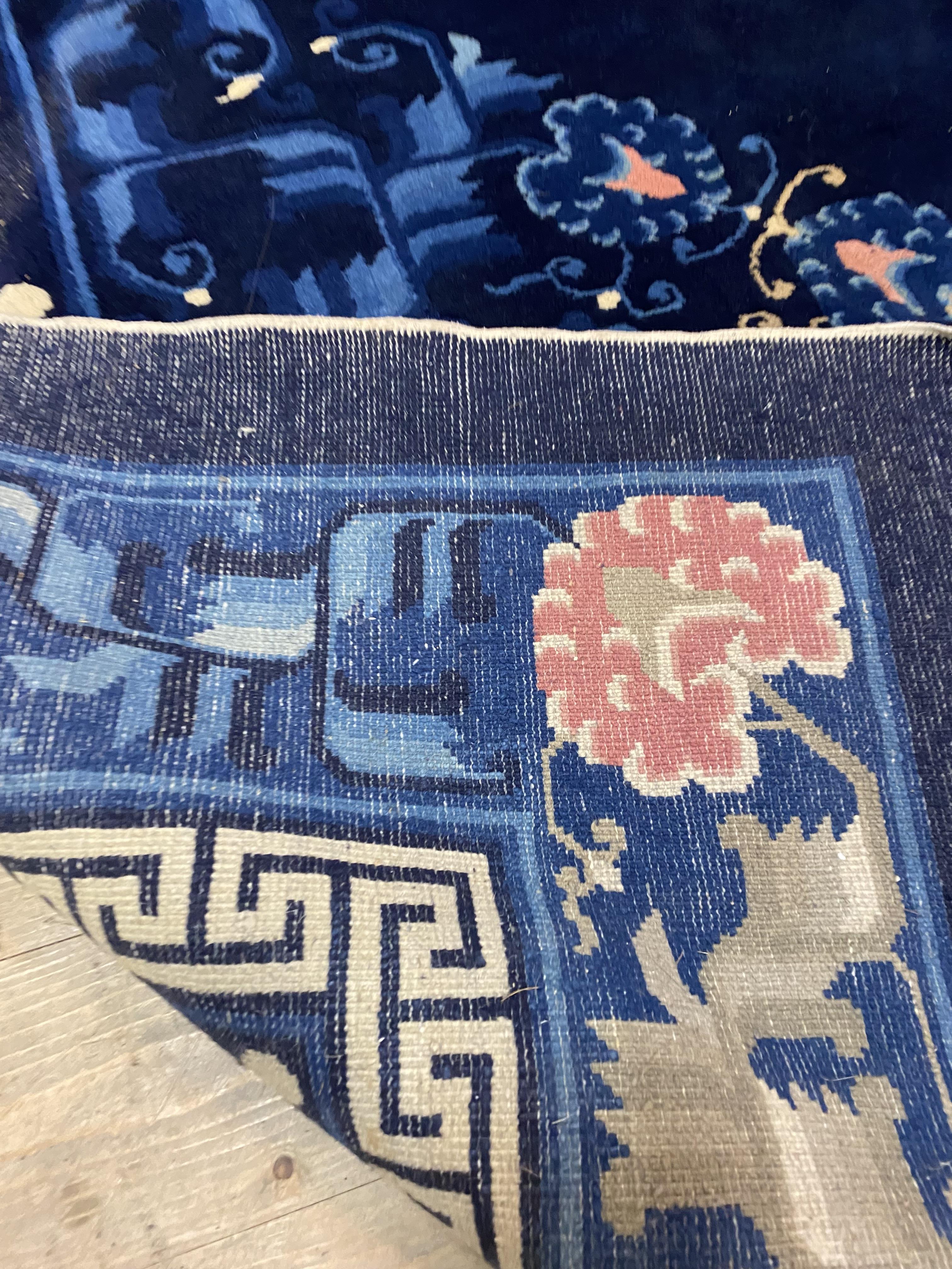 A Chinese super washed wool carpet, the blue ground decorated with repeating medallions and having a - Image 2 of 2