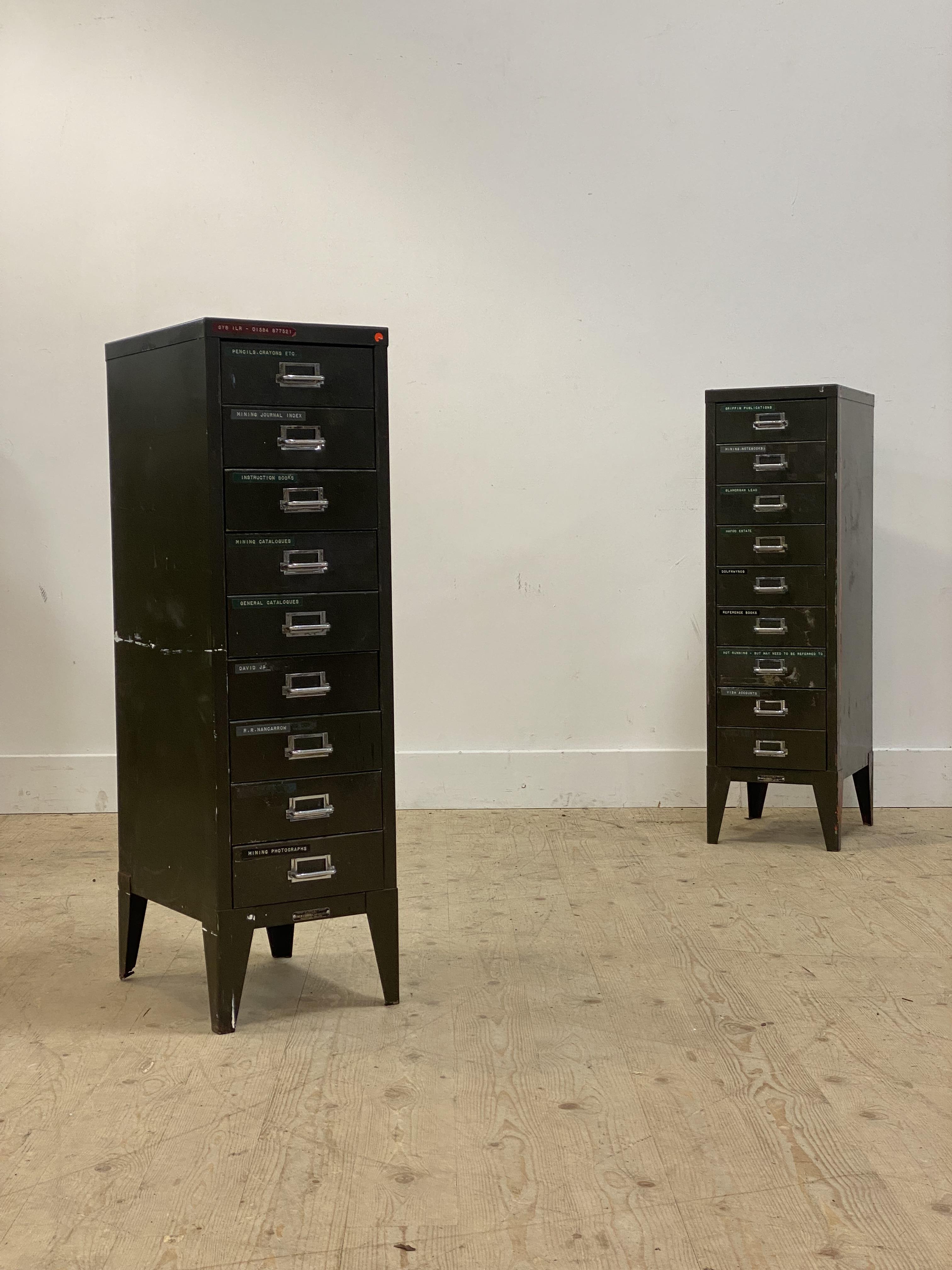 A pair of mid 20th century green painted steel nine drawer index chests. H100cm, W29cm, D39cm.