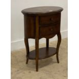 A French style walnut bedside chest of oval outline, the cross banded top centred with eight point