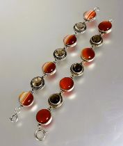 A Scottish silver link bracelet set alternating banded circular polished agate and faceted