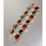 A Scottish silver link bracelet set alternating banded circular polished agate and faceted