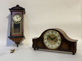 A walnut cased dome top mantel clock by Hermle, with cream dial and Roman chapter ring, the eight