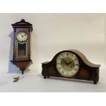 A walnut cased dome top mantel clock by Hermle, with cream dial and Roman chapter ring, the eight