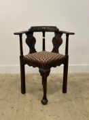 A 19th century oak corner chair, the crest rail, out-swept arms and splats carved with acanthus