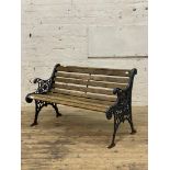 A cast metal and slatted teak three seat garden bench. L126cm.