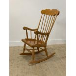 A vintage beech and ply spindle back rocking chair. H114cm.