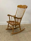 A vintage beech and ply spindle back rocking chair. H114cm.