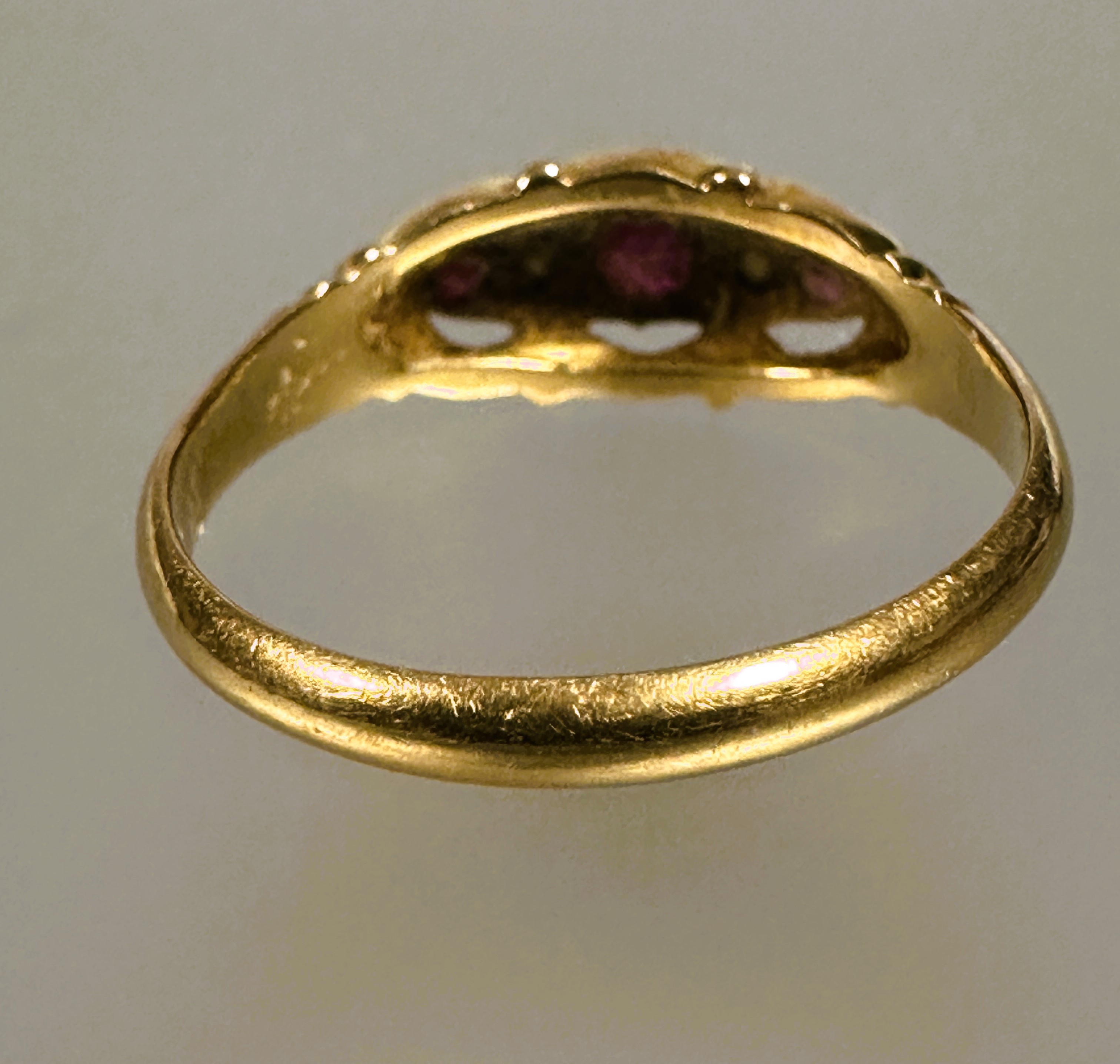 A 18ct gold three stony ruby ring the center cut stone 0.15ct flanked by a rose cut diamond and - Image 2 of 3