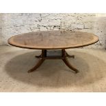 Restall Brown & Clennell, a large Regency style mahogany dining table, the circular top with cross