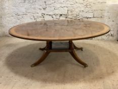 Restall Brown & Clennell, a large Regency style mahogany dining table, the circular top with cross