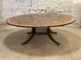 Restall Brown & Clennell, a large Regency style mahogany dining table, the circular top with cross