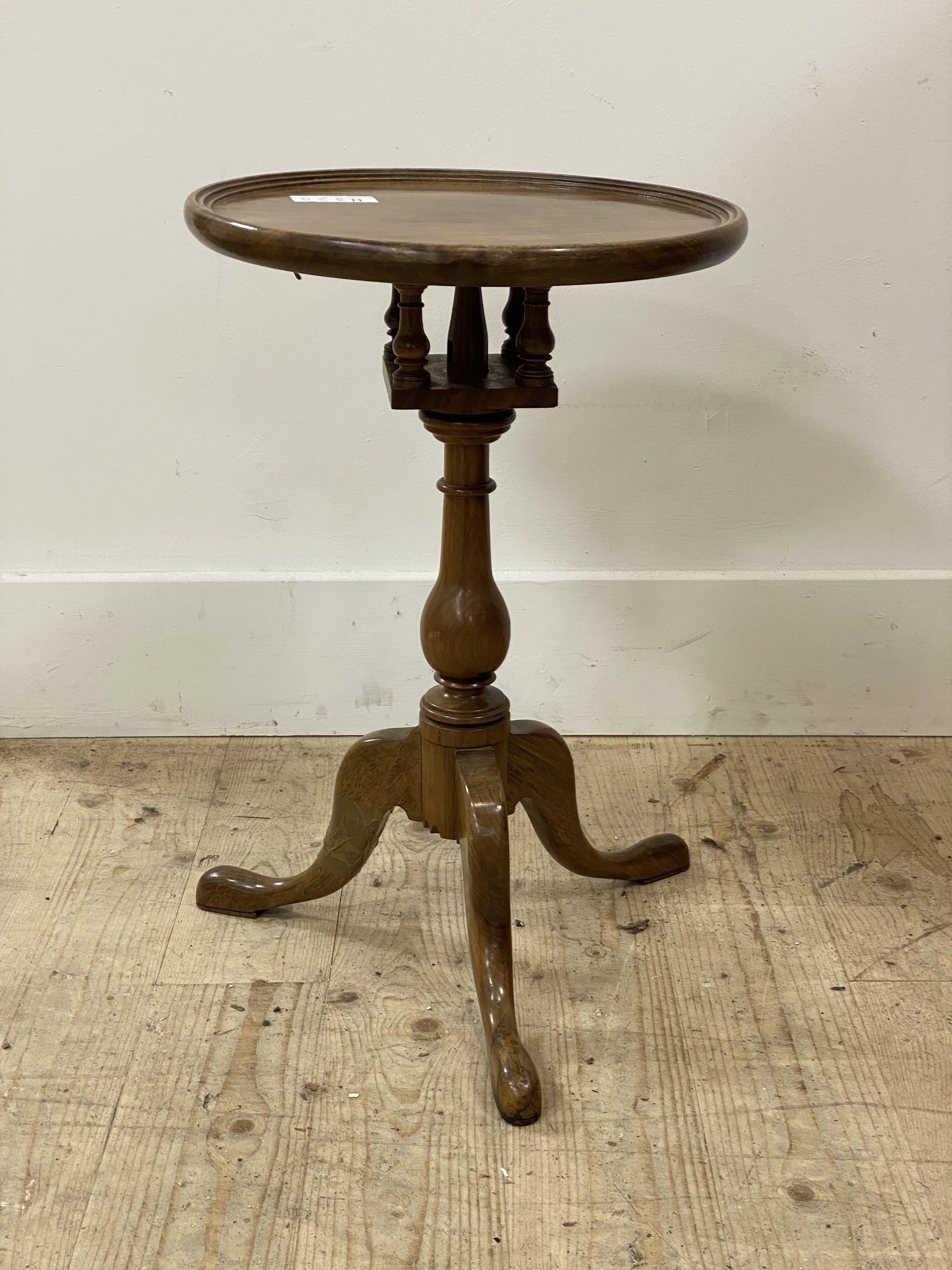 A Georgian style snap top walnut wine table, the circular dished top on bird cage action, raised