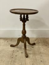 A Georgian style snap top walnut wine table, the circular dished top on bird cage action, raised