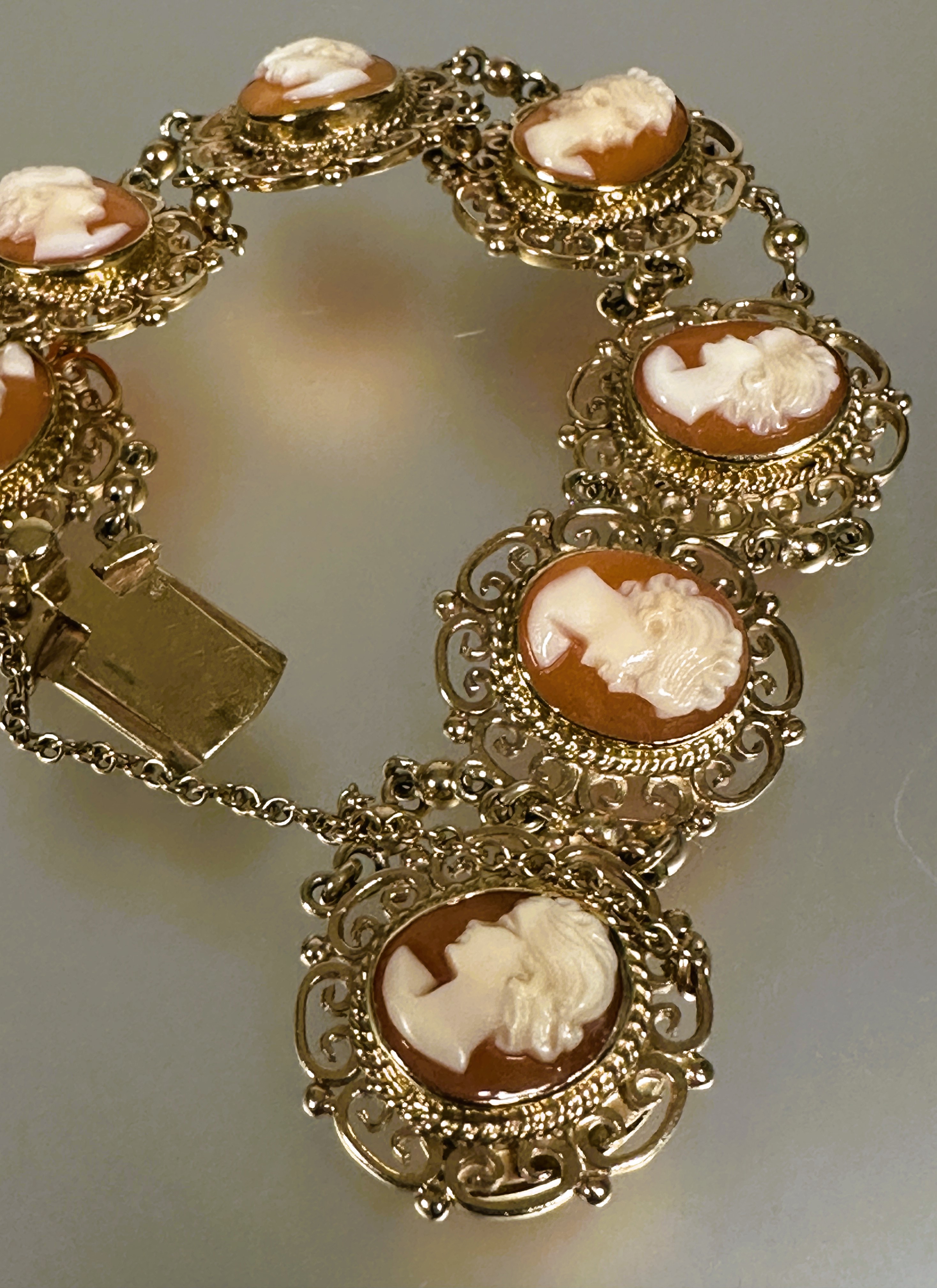 A 9ct gold bracelet set seven shell carved cameos in scrolling open work setting between chain - Image 4 of 4
