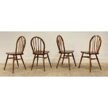 Ercol, a set of four mid century elm and beech dining chairs, circa 1970's, with hoop and spindle