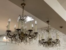 A pair of Victorian style gilt brass eight branch chandeliers, each with pressed glass lustres and