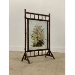 A Victorian bamboo framed fire screen, the glazed panel hand painted in a floral design. H93cm.